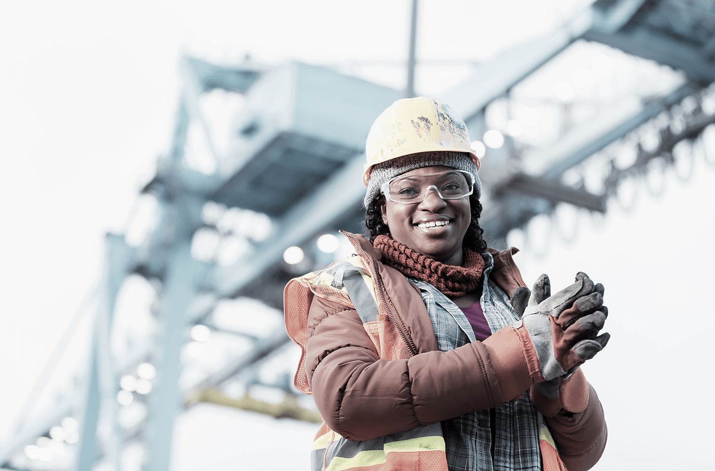 Globalization - Econ - Dock worker standing at the harbor amidst shipping industry activity