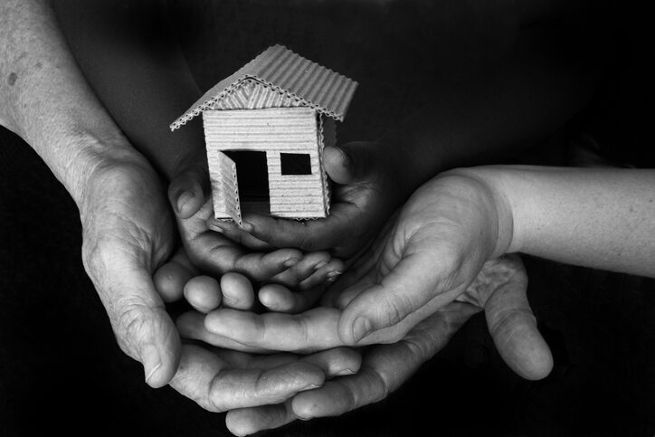 Adult and Child with Cardboard House