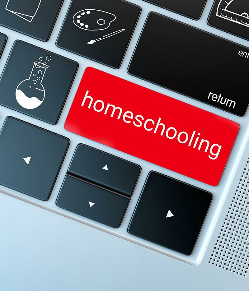 Close-up of Macbook keyboard with custom keys for science, art, and a giant red button marked homeschooling